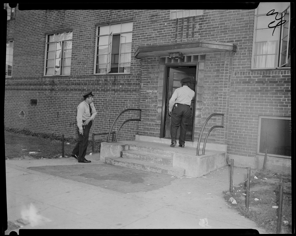 Two police officers entering building