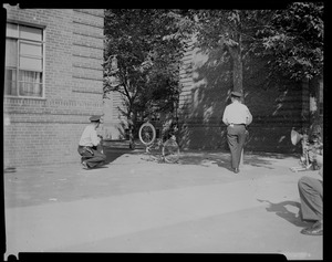 Two officers outside, near bicycle resting on its seat