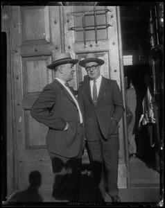 Two men in suits near open doorway of Charles Street Jail