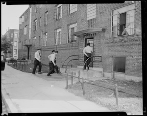 Police officers entering building