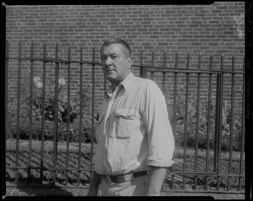 Man next to fence