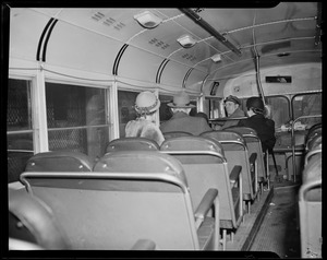 Bus driver and passengers on left side of bus