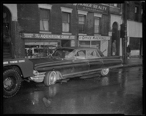 Jerry Ajulio's car, with bullet holes and broken windows, parked in front of The Aquarium Shop near Huntington and South Huntington Avenues