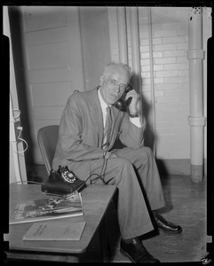 Dr. Paul Dudley White seated and on the phone
