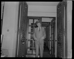 Dr. Paul Dudley White standing in doorway with hands in pockets