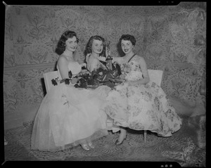 Joan Daly, winner of the Boston Press Photographers Association's Photogenic Queen contest, with trophy, flowers, and two other women