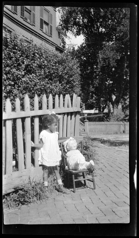 A girl with seated doll