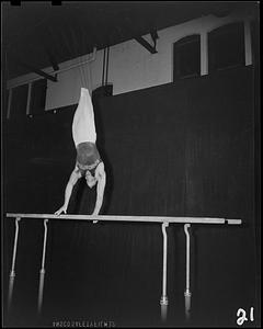 SC gymnast doing handstand on parallel bar