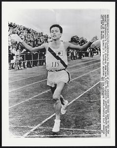 Morio Shigematsu of Japan cross the finish line to win the annual Polytechnic’s 26-mile distance race here 6/12. Shigematsu posted the fastest marathon clocking as he was timed in 2 hours,12 minutes for the grueling event, shaving 11.2 seconds off the old record.