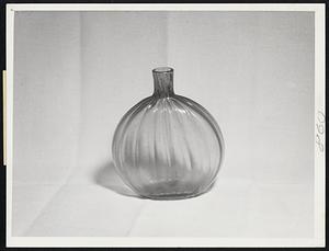 The Grace of Ohio Glass is seen in the elegant lines of this bottle. Many different colors distinguish the product of the Ohio glasshouses, and the finished examples have solidity and resonance.