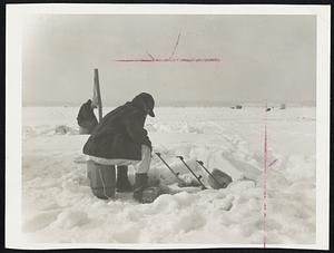 Its Great Sport if you can Stand the Cold- Eben Pevear of Hampton, N.H. bundled up against the cold, sits on a barrel and watches his lines while fishing for smelt on Great Bay, near Greenland, N.H.