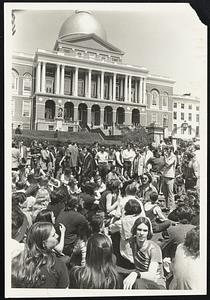 Blocking at front of State House by sitting in at front of State House.