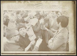 Burn Draft Cards--Demonstrators against the Vietnam wat burn draft cards today in Central Park, New York City. Youth at right holds burning coffee can, from which demonstrators lighted their cards. The card burning carried on for 15 minutes during the mass peace demonstration in the Sheep Meadow section of the park.