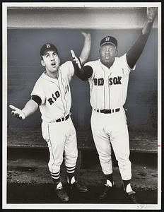 Rain, Rain, Go Away was plea of Rico Petrocelli and George Scott as they lift arms skyward from Fenway dugout Friday night. Well equipped to wait it out, at right, were fans Miss Mary McNeely and her pretty niece, Jayne McNeely, of Watertown.