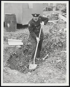 Patrolman James Hitaffer looking for stuff at 187 Malden St. Liquor-Poison Liquor.