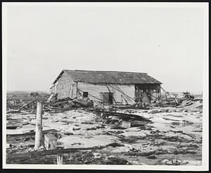 Results Of A Grim Reaper. Earthquake area, Hokkaido -- The earthquake and tidal wave which swept the Hokkaido area recently left this grim reminder, the sole remaining home left standing at the town of Kiritappu which once contained 800. The huge tidal waves and six foot ice cakes destroyed the rest and laid waste to the countryside, leaving countless victims homeless and destitute. The 315th Air Division (Combat Cargo) airlifted hundreds of pounds of American Red Cross clothes to the stricken victims. The only one of 800 homes at Kiritappy which survived the tidal wave. All of the others were washed away clean by the combined pounding of the wave and the six foot ice cakes.