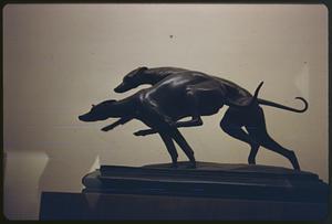 Sculpture of two dogs in motion