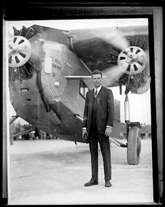 Charles Lindbergh standing in front of his plane, "Spirit of St. Louis"