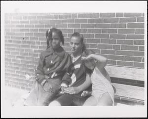 Trio of girls on a bench in the sun