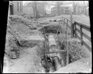 Cement casing around town water pipe over arches