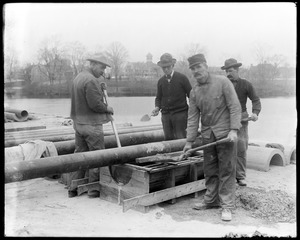 Cement covering for town water pipe over arches (making)