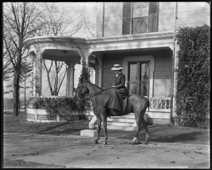 Mrs. L. Talbot on horseback in front of house