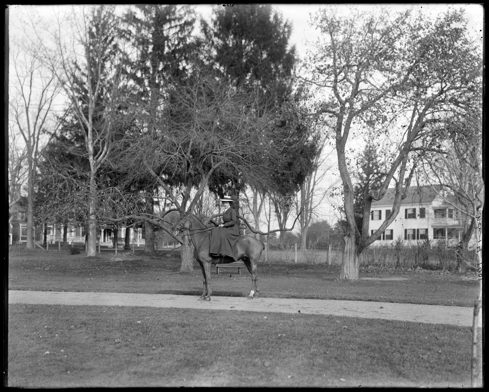 Mrs. L. Talbot on horseback in front of house