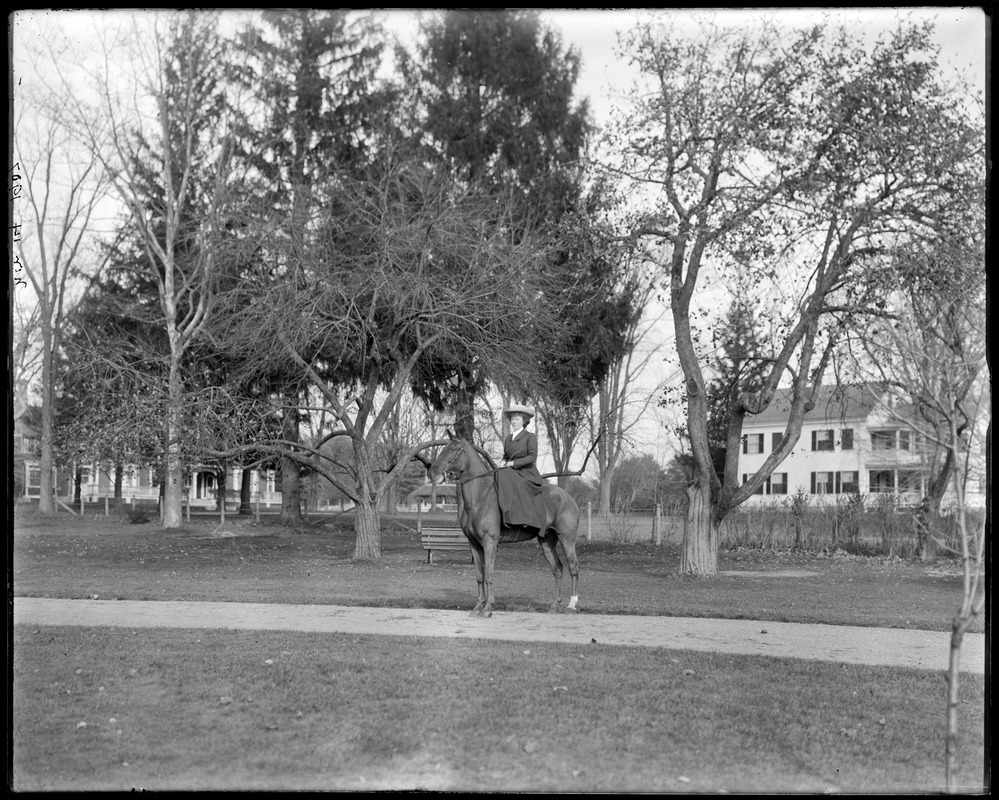 Mrs. L. Talbot on horseback in front of house