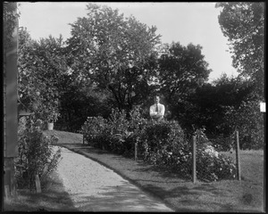 #90 Wilson Street, W. Radcliffe standing in flower garden