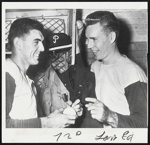 Curt Simmons and Replacement in Phillies dressing room before opening game of World Series. Simmons (left) is not eligible for World Series participation, but is on 10-day furlough from Camp Atterbury, He is pitching batting practice. On the left and getting an autographed baseball is Jocko Thompson, Greater Boston, product, who was declared eligible for the Series as the Simmons replacement.