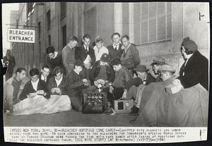 Bleacher Hopefuls Come Early -- Equipped with blankets and Lunch boxes, fans who hope to gain admission to the Bleachers for tomorrow's opening World Series game at Yankee Stadium here passed the time with card games after taking up positions outside the Bleacher entrance today.
