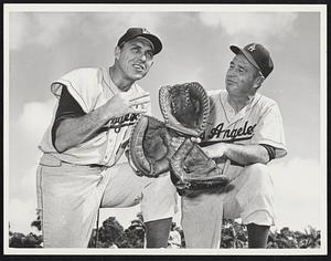 Handy Man-Walter Alston tells Gil Hodges that he is to fill a utility role as first and third baseman, outfielder and catcher with the Los Angeles Dodgers. The manager hands the 37-year-old the required three gloves for the job.