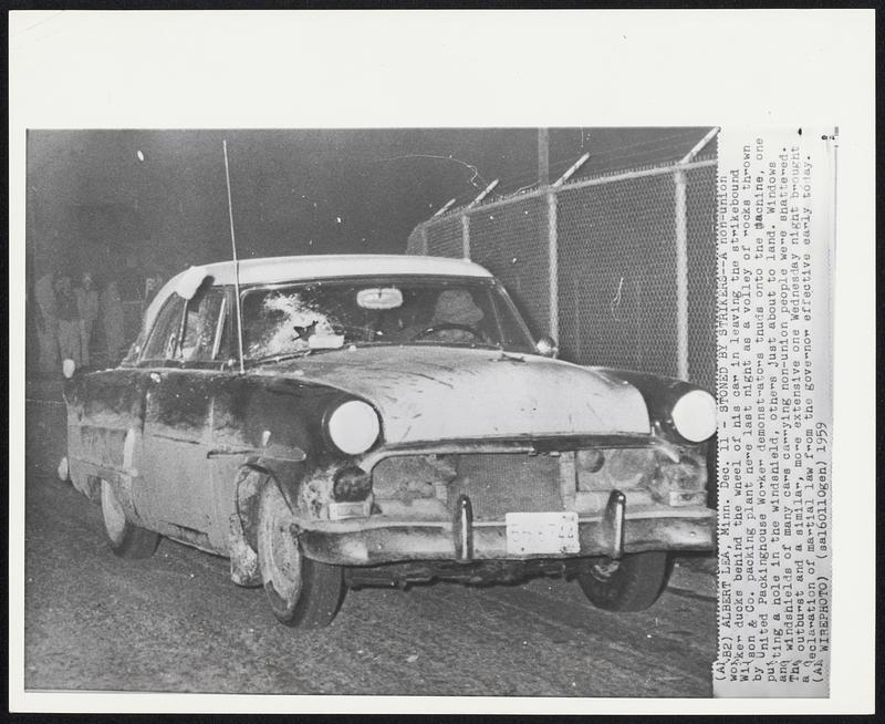 Stoned by Strikers--A non-union worker ducks behind the wheel of his car in leaving the strikebound Wilson & Co. packing plant here last night as a volley of rocks thrown by United Packinghouse Worker demonstrators thuds unto the machine, one putting a hole in the windshield, others just about to land. Windows and windshields of many cars carrying non-union people were shattered. The outburst and a similar, more extensive one Wednesday night brought a declaration of martial law from the governor effective early today.