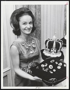 Millions of Dollars of diamonds (in replica) are displayed by pretty Barbara Anthony of Brookline, above. The gems are displayed in announcing the Diamond Jubilee Ball and Dinner, celebrating the city of Quincy's 75th anniversary. Event will be held Friday, Dec. 13, at Sheraton Motor Inn,