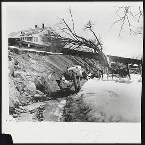 Vermont Landslide-Mail boxes in foreground are 30 feet below their former position following a landslide that ripped out a quarter of a mile of road at Weybridge, Vt. Porch of farm house at left is hanging over washout. Road won't be repaired until spring.