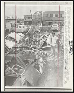 A Corpus Christi resident looks over the damage caused by a television tower that fell into a parking lot, flattening a number of cars. The tower was only a small part of the damage caused by the passage of Hurricane Celia, packing 115 mph winds with gusts even higher. Celia crossed over Corpus Christi late 8/3.