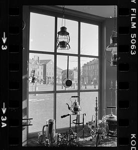 Window display of lanterns and silver goods