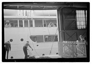 People waving from a ship