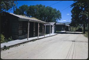 Dirt road and row of wooden buildings, Nevada City, Montana
