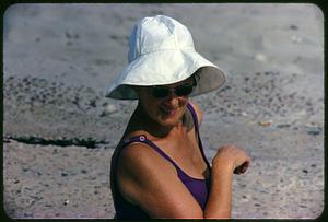 Woman wearing swimsuit and sun hat on beach, Revere Beach