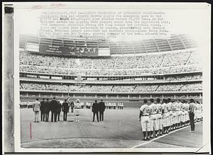 Opening Ceremonies at Riverfront Stadium -- The Cincinnati Reds and Atlanta Braves played the inaugural game in the city's new $40,000,000 plus stadium before 51,050 fans. As the National Anthem was played, Reds players stood down the rightfield line, with inaugural officials facing the flag behind the pitching mound. Third and fourth from left -- back to camera, respectively were Charles Feeney, National League president and Baseball commissioner Bowie Kuhn. At far right was Bob Howsam, general manager of the Reds. Atlanta won, 8-2