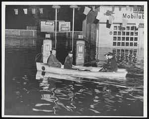 Flooded Peabody- Boats replaced cars in Peabody as water rushed through a 40-foot hole in a dam and flooded two square miles in the heart of the city. Top picture, police do duty in a rowboat.