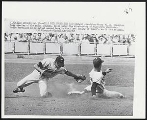 Los Angeles – Wills Gets Under The Tag – Dodger speedster Maury Wills, champion base stealer of the major leagues, slips under the stretch-tag of Minnesota shortstop Zoilo Versalles as he swiped second base in the first inning of today’s World Series game.