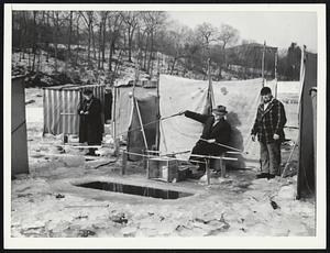 Smelt Fishing on Neponset River, near Milton Basin more than 75 shelters have been built by the 100 or 150 smelt fisherman who have been fishing through the ice since Dec. 26. (two men on right are (LtoR) Arthur Groos of Dorchester Lower Mills, & Johnny De Celle a Quincy fireman.