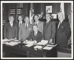 New Era for Home - Secretary of State Kevin White signs document changing the name of the Hebrew Home for the Aged to the Hebrew Rehabilitation Center for Aged. Standing, left to right, are Jacob Rabinovitz, treasurer; Samuel Rabinowitz, first vice president; Harry Marks, chairman of the executive committee; Herbert Skalsky, secretary; Harold Widett, president; David Kane, second vice president.