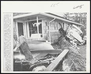 Tidal Wave Effect - Hugh tree trunk and two automobiles were swept against this home in Seaside on north Oregon coast last night. Seaside and nearby Cannon Beach were hardest hit of Oregon communities but effect was felt from Columbia River south to California border.