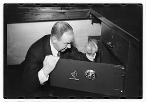 A man demonstrating how to break into a safe
