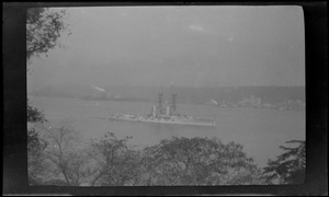Battleship with lattice masts on the Hudson River, from Manhattan