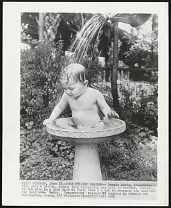 Cure for Hot Weather-- Pamela Klein, 10-months-old, gets a cooling shower from sprinkling can held by brother, Bradley, as she sits in a bird bath at their home to try to overcome the sweltering heat wave today. Temperature reached 95 degrees in Chicago and surrounding area.