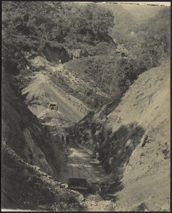 Railroad track construction through tree-covered mountains
